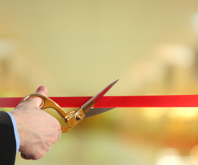 Ribbon being cut with gold scissors